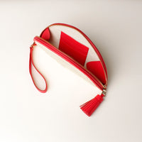 An open Clutch Agnes Junco ROT with red leather details, gold hardware, upper view