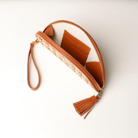 Interior view of a clutch Agnes Raffia Intertwined with tan leather details, strap and tassel, with three slots for cards