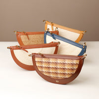 Set of five woven handbags with leather accents on a neutral background