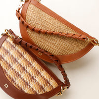 Two woven handbags with braided handles on a light background