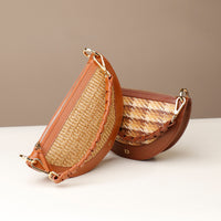 Two straw handbags with brown leather accents on a white surface.