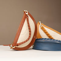 Three handbags with brown and beige straps on a neutral background