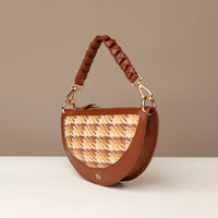 Brown handbag with woven pattern on a beige background
