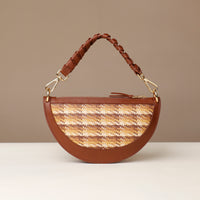 Brown handbag with woven pattern on a beige background