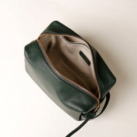 Top view of open green Compact leather dopp kit for men and women by Danilos