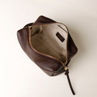 Top view of open brown Compact leather dopp kit for men and women by Danilos