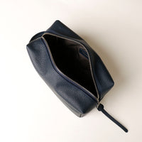 Top view of open blue Compact leather dopp kit for men and women by Danilos