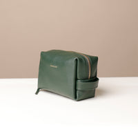 Side view of green Compact leather dopp kit for men and women by Danilos