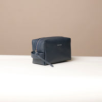 Side view of blue Compact leather dopp kit for men and women by Danilos