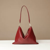 Red handbag on a beige background