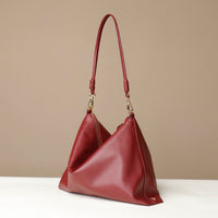 Red handbag on a beige background