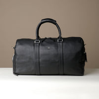 Front View of Black Premium leather duffle bag designed for travel with spacious interior, durable construction, and refined details