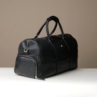 Angled View of Black Premium leather duffle bag designed for travel with spacious interior, durable construction, and refined details