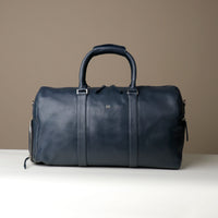 Front View of Blue Premium leather duffle bag designed for travel with spacious interior, durable construction, and refined details
