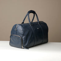 Angled View of Blue Premium leather duffle bag designed for travel with spacious interior, durable construction, and refined details