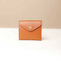 A closed Anahí wallet made of leather, with a color block design in brown and white, and a visible brand letter 'D'.