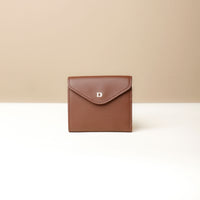 A brown, compact, block-patterned leather wallet with a secure magnet snap closure and a small brand embossment on the front.