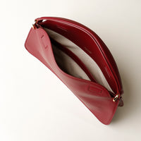 Open interior of red Penelope Mini small leather handbag for versatile everyday use