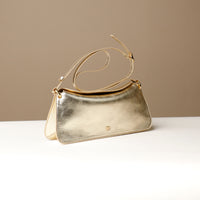 Side view of gold Penelope Mini small leather handbag for versatile everyday use