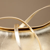 Close up view of gold Penelope Mini small leather handbag for versatile everyday use