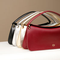 A collection of Penelope Mini small leather handbag for versatile everyday use