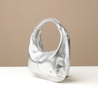 Side view of silver Soft Rounded Bag crescent leather top-handle handbag