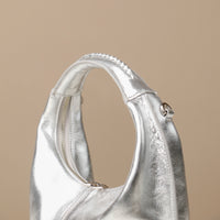 Close up view of silver Soft Rounded Bag crescent leather top-handle handbag