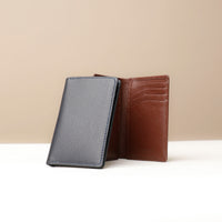 A brown and black leather card wallet with a polished pebble leather lining, featuring multiple credit card slots.