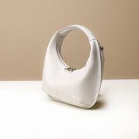 Side view of Soft Rounded Bag crescent leather top-handle handbag