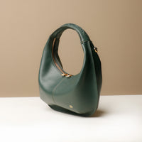 Side view of green Soft Rounded Bag crescent leather top-handle handbag