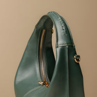 Close up view of green Soft Rounded Bag crescent leather top-handle handbag