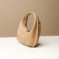 Side view of brown Soft Rounded Bag crescent leather top-handle handbag