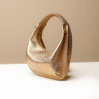 Side view of gold Soft Rounded Bag crescent leather top-handle handbag