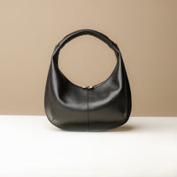 Front view of black Soft Rounded Bag crescent leather top-handle handbag