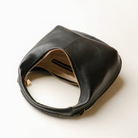 Open interior of black Soft Rounded Bag crescent leather top-handle handbag
