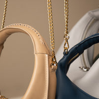 Close up view of Soft Rounded Bag crescent leather top-handle handbag strap
