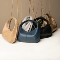 A collection of Soft Rounded Bag crescent leather top-handle handbag