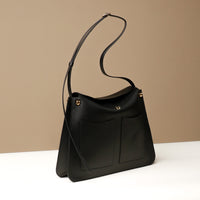 Black Penelope Sr. leather shoulder bag – sophisticated structured purse with front pockets and magnetic closure