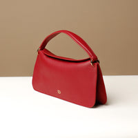 Side view of red Penelope Mini small leather handbag for versatile everyday use