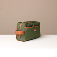 Angled View of Green and Orange Fabricio leather toiletry bag with roomy interior and organized compartments, perfect for travel or everyday storage of essentials