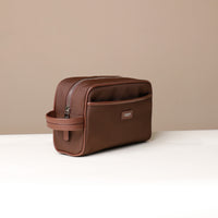 Angled View of brown Fabricio leather toiletry bag with roomy interior and organized compartments, perfect for travel or everyday storage of essentials