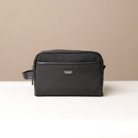 A Black Fabricio leather toiletry bag with roomy interior and organized compartments, perfect for travel or everyday storage of essentials