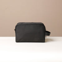 Back view of black Fabricio leather toiletry bag with roomy interior and organized compartments, perfect for travel or everyday storage of essentials