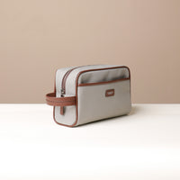 Angled View of Grey Fabricio leather toiletry bag with roomy interior and organized compartments, perfect for travel or everyday storage of essentials