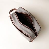 Open Grey Fabricio leather toiletry bag with roomy interior and organized compartments, perfect for travel or everyday storage of essentials