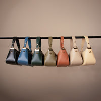 A collection of Hold Bag by Danilos in smooth leather in black, blue, green, olive, brown,beige, and white