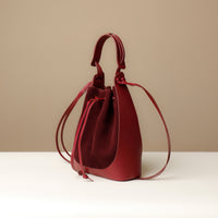 Side view of Suede Tulipa Bag showing structured leather front