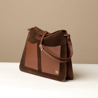 Side View of Brown Suede Penelope Sr. bag in Brown with fold-over magnetic closure