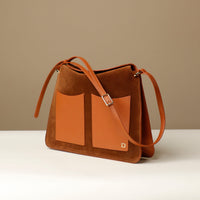 Side view of Suede Penelope Sr. bag in Brown with fold-over magnetic closure