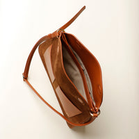 Open interior of Suede Penelope Sr. bag in Brown with fold-over magnetic closure